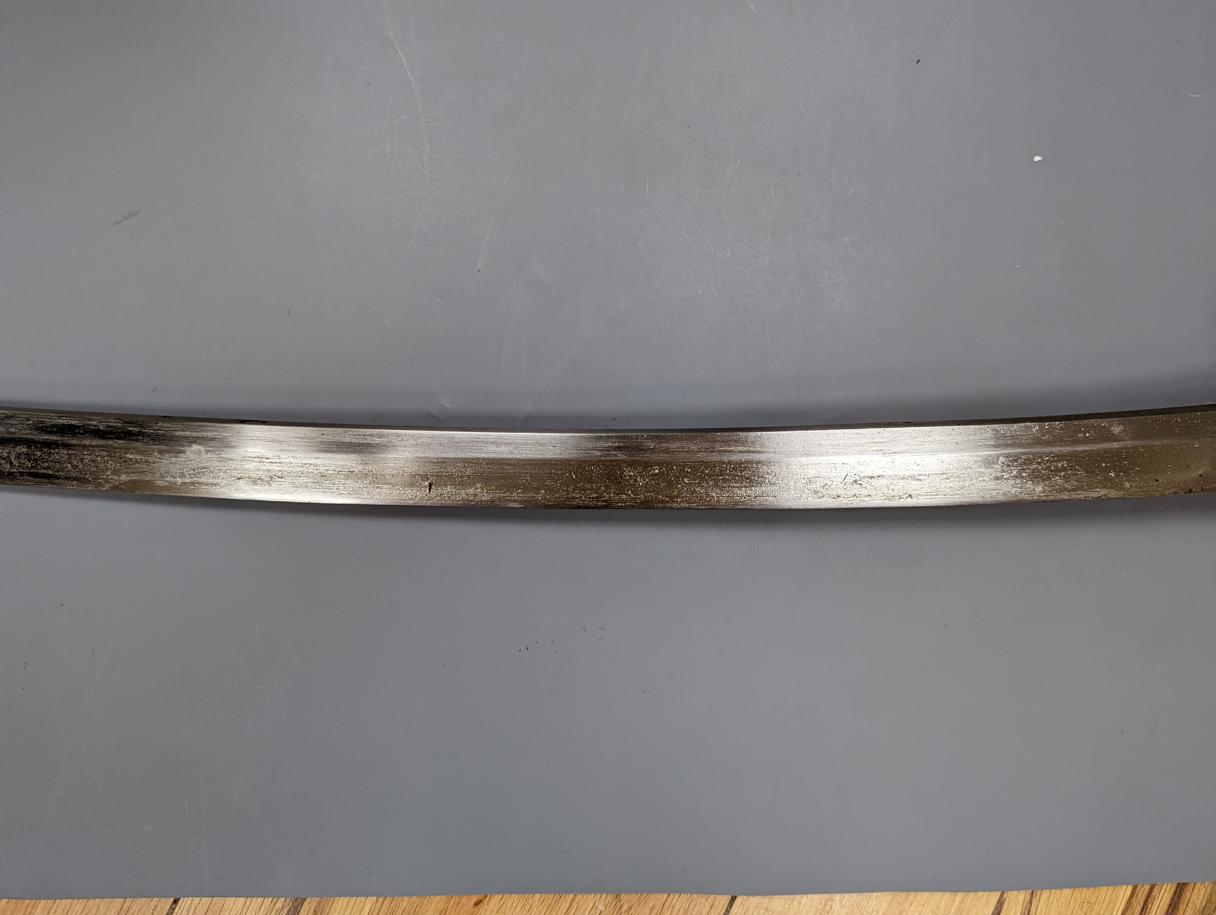 A Japanese Katana with leather covered sheath, plaque reading ‘Presented to Capt. S. Mear Telecoms B.M.A’ 93 cms long.